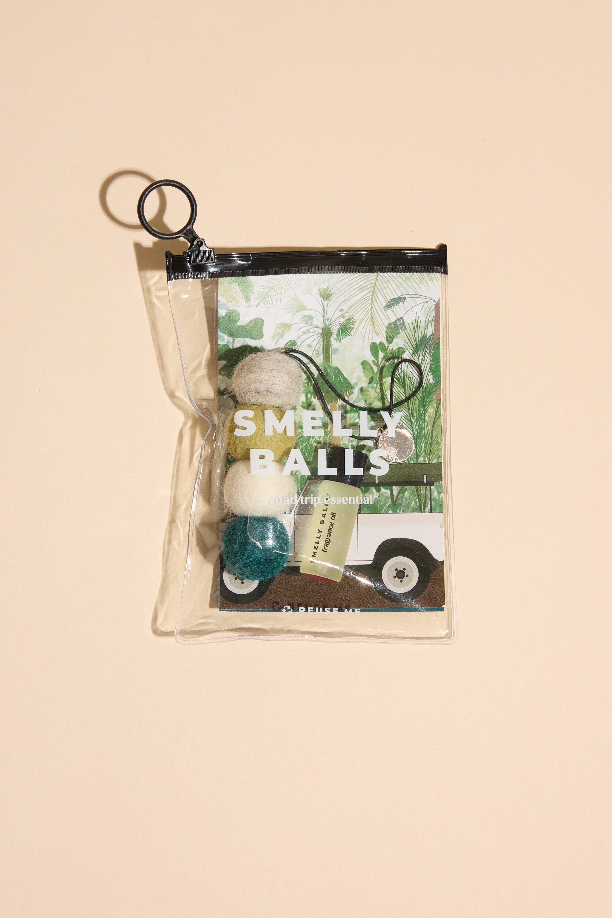 The Smelly Balls: Serene / Native Trees by Other features four colorful felt balls, a small bottle, and a illustrated card in a clear zippered pouch—an ideal nature-inspired car accessory with native tree fragrance.