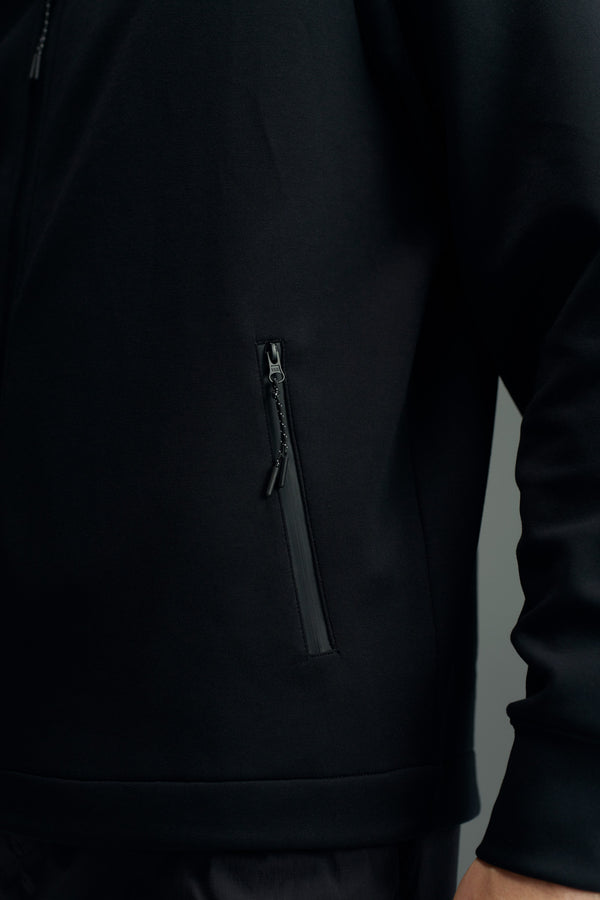 Close-up of a person wearing the WearEver Altitude Hoody by WearEver, highlighting the zippered side pocket and lower sleeve—an ideal everyday tech fleece layer.