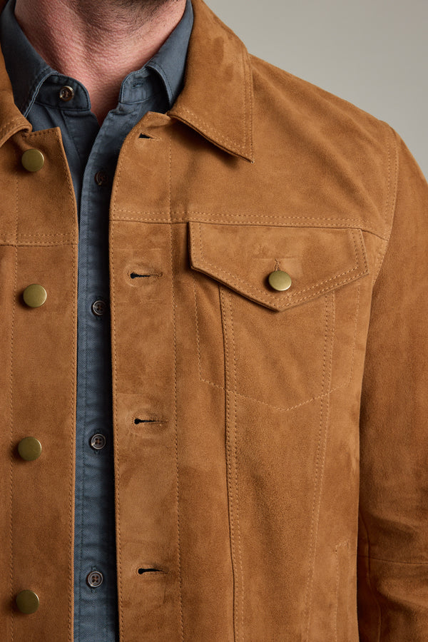 Man wears Barkers Jackson Suede Trucker over a blue button-up, shown neck to waist.