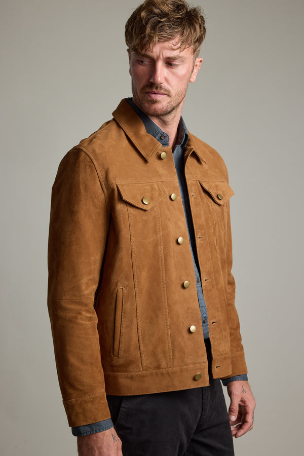 Man wearing Barkers Jackson Suede Trucker over a blue shirt, looking to his left.