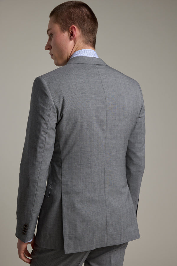 A man stands facing away, showcasing the back of the Barkers Henderson Houndstooth Suit Jacket against a plain, neutral background.