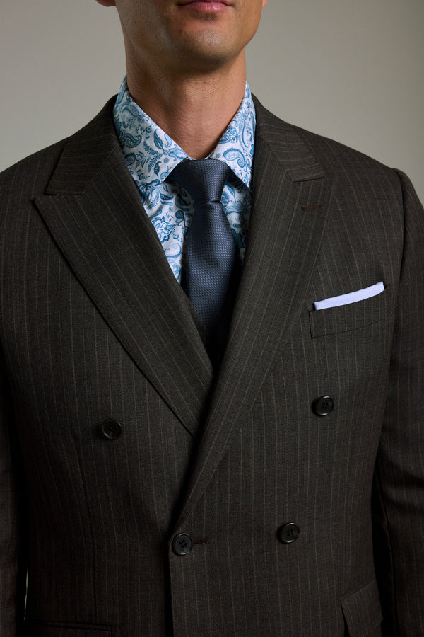 Man in Barkers Radcliffe Stripe Double Breasted Suit Jacket, blue paisley shirt, navy tie.