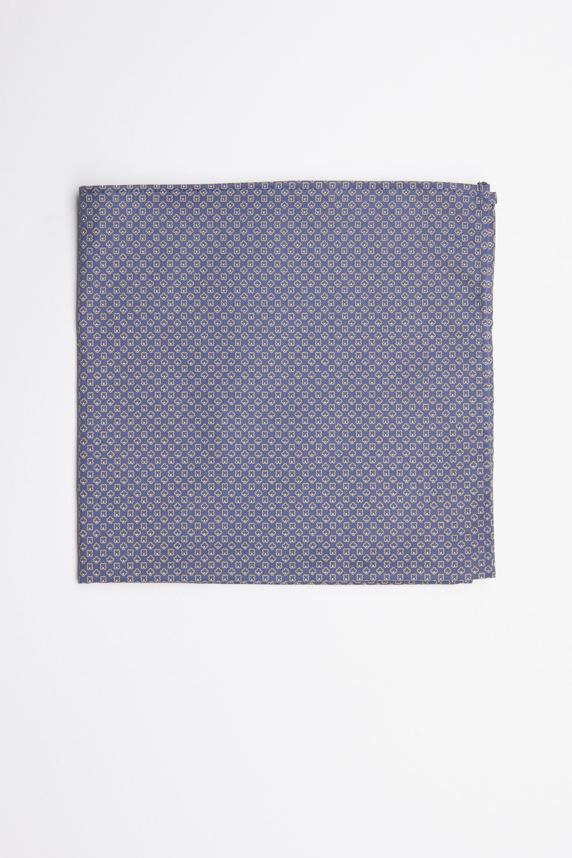 The Erin Geo Pocket Square by Barkers features a neatly folded blue design with a small, repeating circular pattern—an elegant men's formal accessory displayed on a white surface.