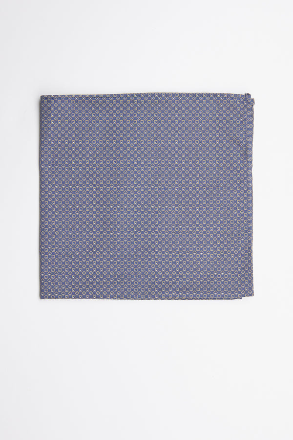 The Erin Geo Pocket Square by Barkers features a neatly folded blue design with a small, repeating circular pattern—an elegant men's formal accessory displayed on a white surface.