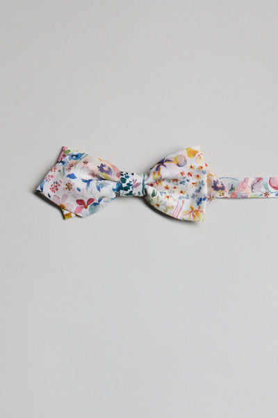 The Liberty Felda Bow Tie by Liberty, handmade in New Zealand from Tana Lawn cotton with a vibrant floral design, is shown laid flat on a light gray background.