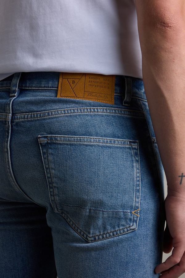 Model in Barkers Rambler Denim Slim Jean, highlighting back pocket and branded waistband label.