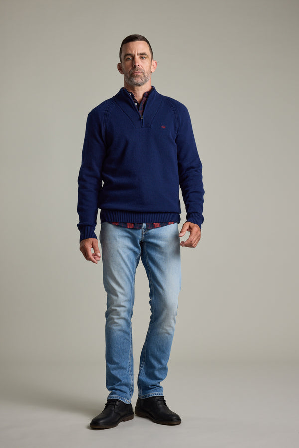 Man in Barkers Rowley Woollen 1/4 Zip, light jeans, and black shoes on a plain background.