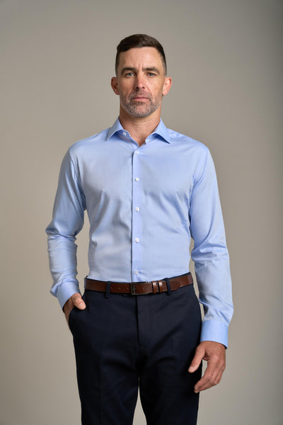 Man in a Barkers Tribeca Reg Cuff Shirt and dark pants against a plain background.