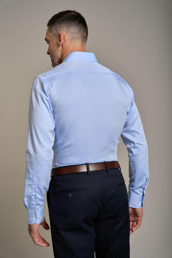 Man in a Barkers Tribeca Reg Cuff Shirt (light blue) and dark pants, seen from the back.