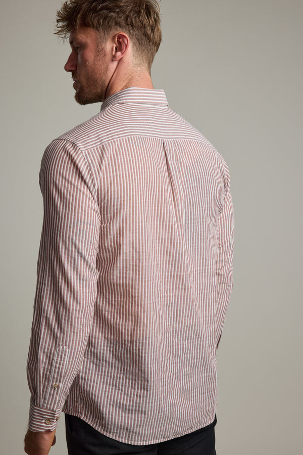 A man with light brown hair is seen from behind wearing the Barkers Sumter Stripe Shirt, a lightweight long sleeve top featuring vertical pink and white stripes, set against a plain light background.