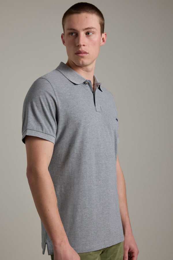 A man in a Barkers Regent Pique Polo looks left against a plain background.