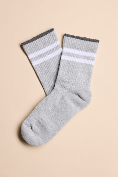 A pair of Barkers Emerson Sport Socks with white stripes and dark gray cuffs on beige.