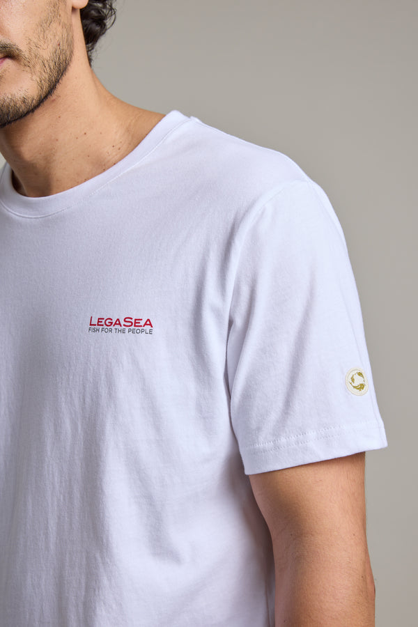 Man wearing Legasea Brand Tee, organic cotton, red logo and text on chest.