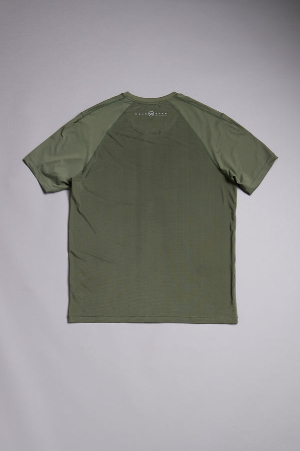 The WearEver Pulse Tee by WearEver is a plain olive green performance t-shirt, shown flat from the back, featuring raglan sleeves, moisture-wicking fabric, and a small circular logo near the neckline.