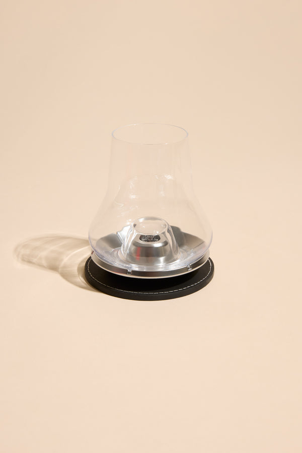 Other Whisky Glass Individual with metal cooling base on black coaster, beige background.