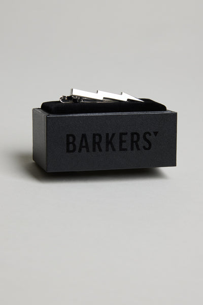 The Barkers Lightning Tie Clip, in polished silver-tone, rests in a black velvet box marked "BARKERS"—a stylish accent to elevate any formalwear.