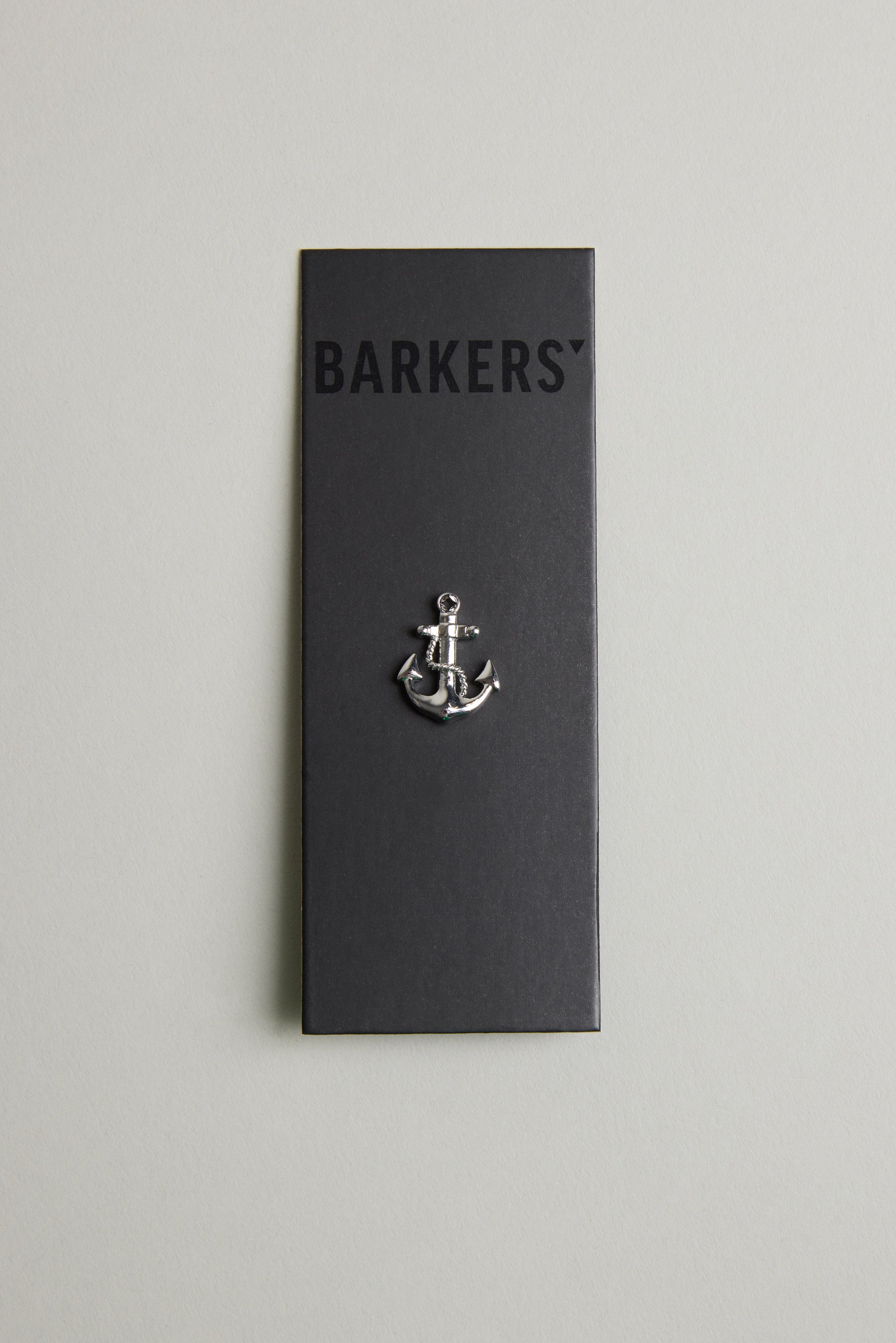 The Barkers Anchor Lapel Pin, displayed on a black card with the brand name at the top and a light grey background, makes an ideal nautical accessory or gift for ocean lovers.