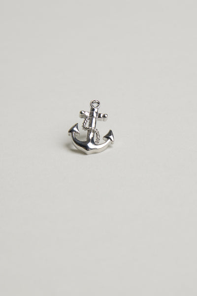 The Barkers Anchor Lapel Pin, a small shiny silver accessory shaped like an anchor, is displayed centered on a plain light gray background—ideal for nautical style or as a gift for ocean lovers.