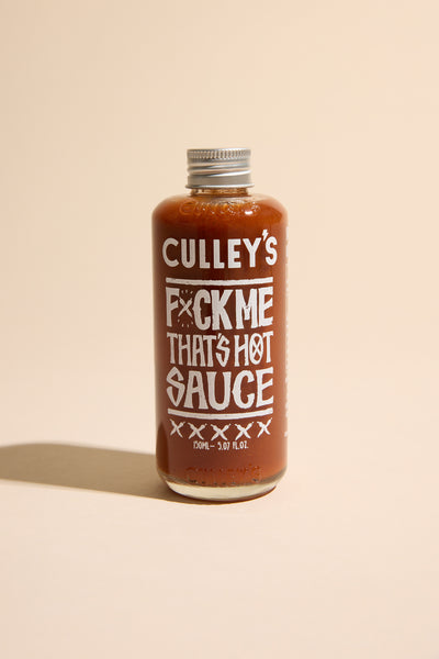 Culley’s F@#k Me That’s Hot Sauce bottle on a beige background.