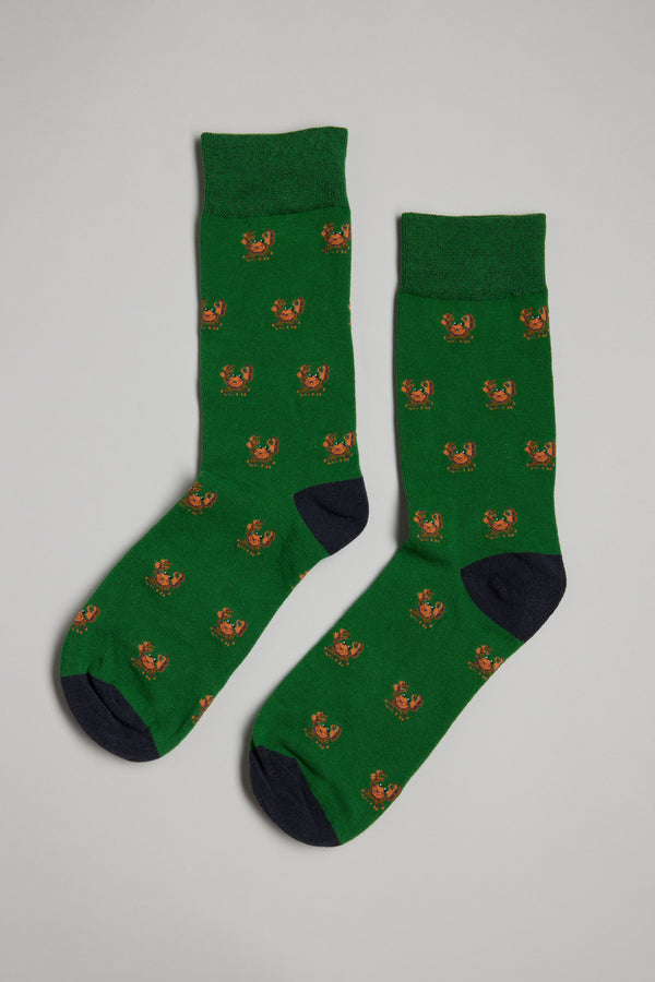 The Barkers Crab Sock is a green men's cotton sock with small orange crab patterns, black toes and heels—perfect as a gift—shown on a light gray background.