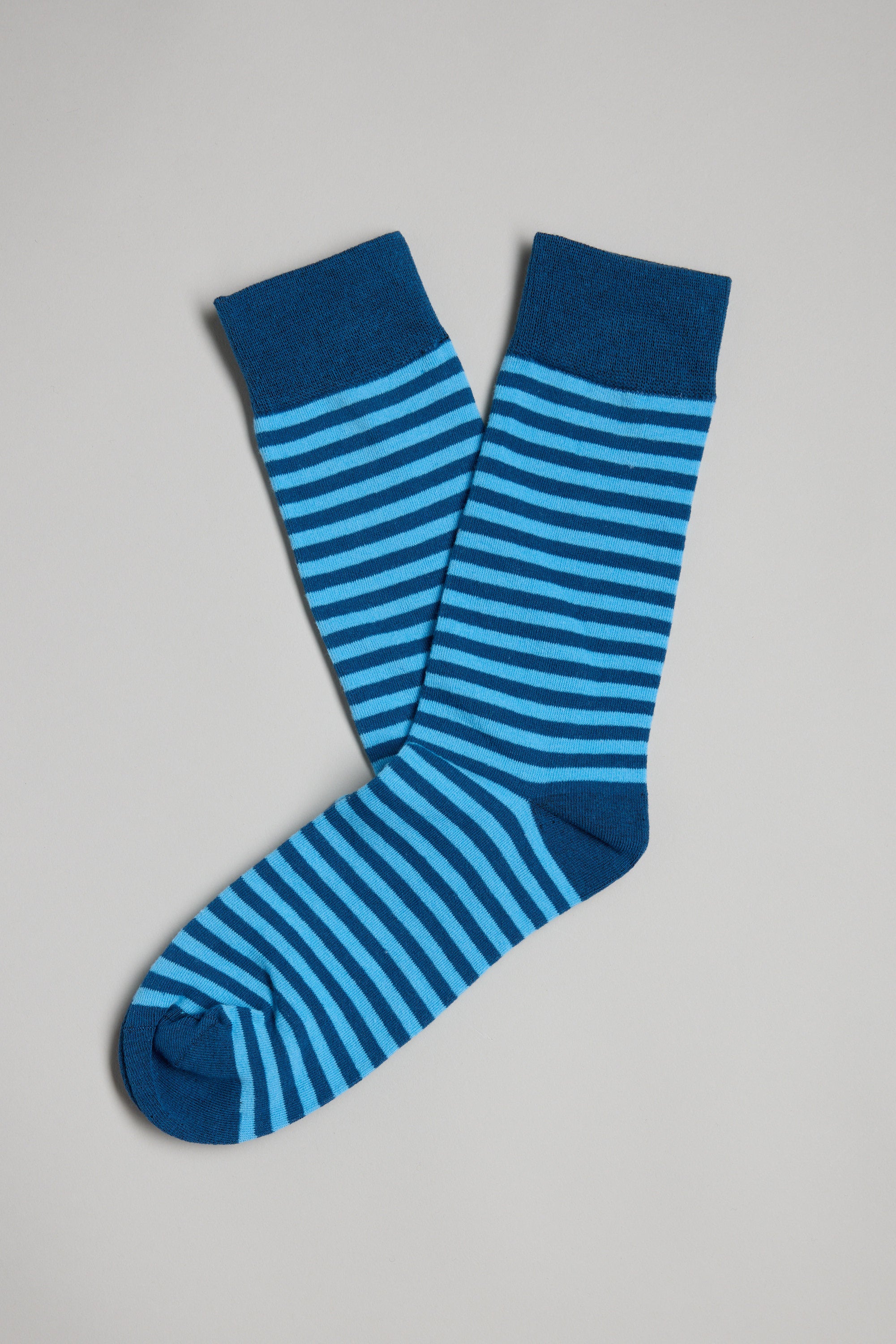 A pair of Barkers Evans Stripe Socks with light and dark blue horizontal stripes, shown flat on a light gray background—stylish personality socks and an ideal gift for men.