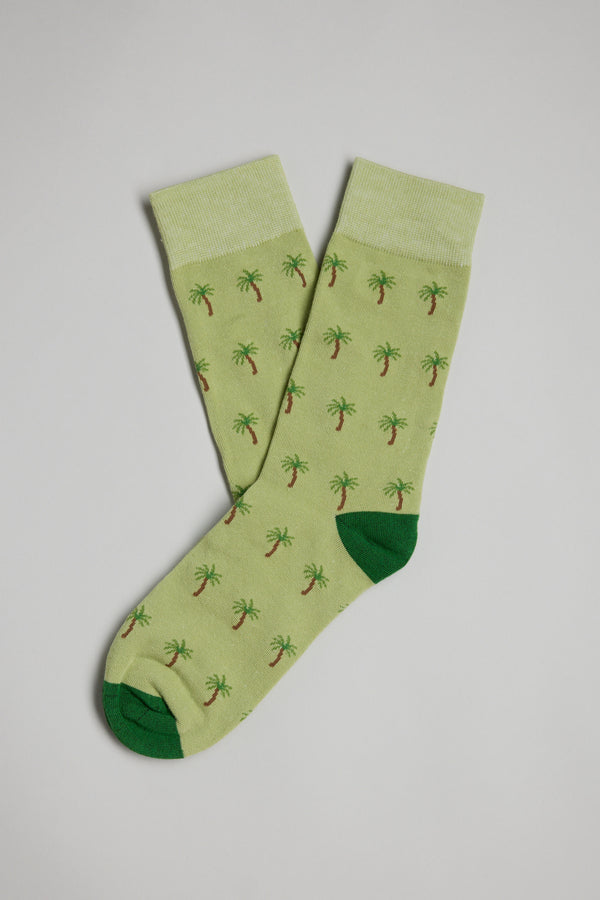 The Barkers Palm Tree Sock features light green fabric with green toes and heels and a repeating small palm tree pattern, displayed flat on a plain, light background.