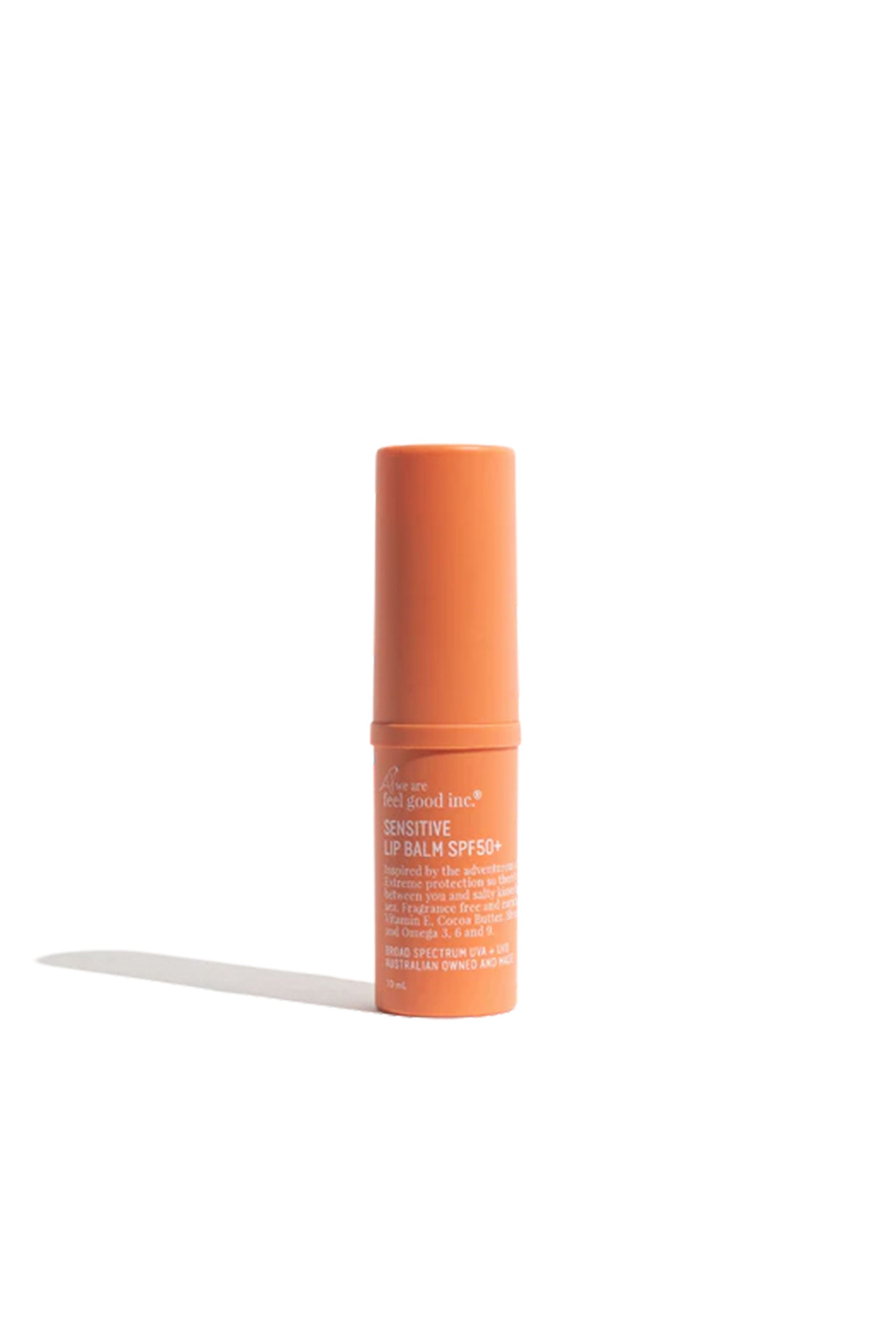 An orange tube of Other Sensitive Lip Balm SPF50+ 10ml stands upright on a white background, casting a faint shadow beside it.