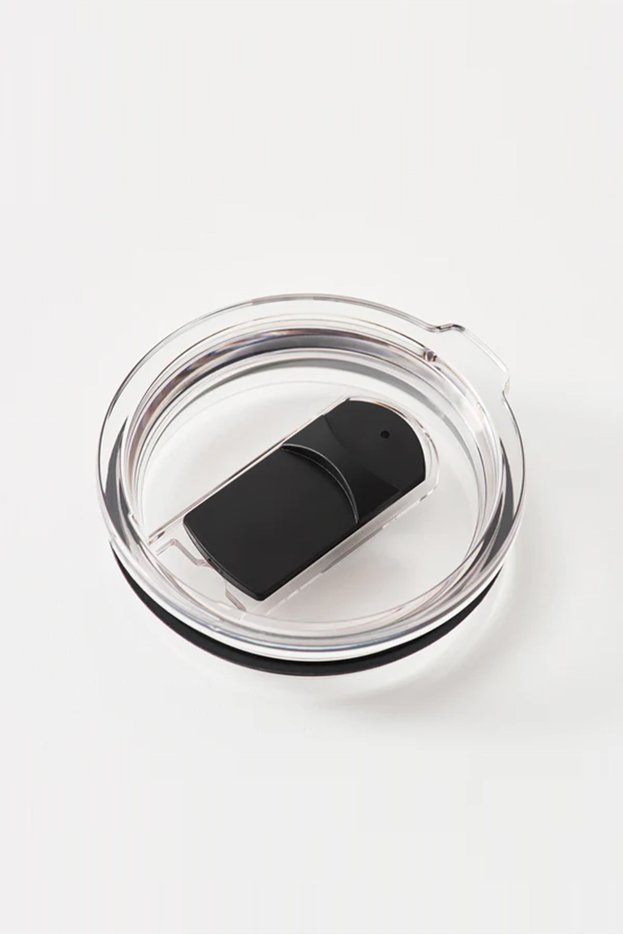 A clear round plastic lid with a black sliding closure, made for the Huski Short Tumbler 2.0 by Huski or other vacuum insulated tumblers, is displayed against a plain white background.