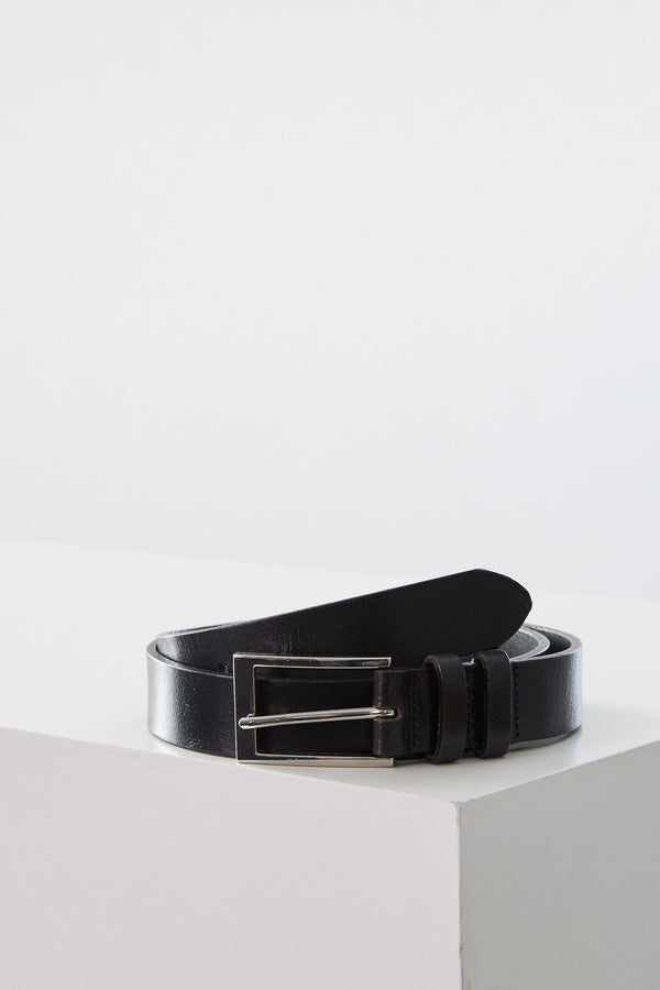 The Barkers Frances Leather Belt, featuring a black leather strap and a square buckle, is rolled up on a white surface. This classic accessory adds timeless style to any outfit in New Zealand.