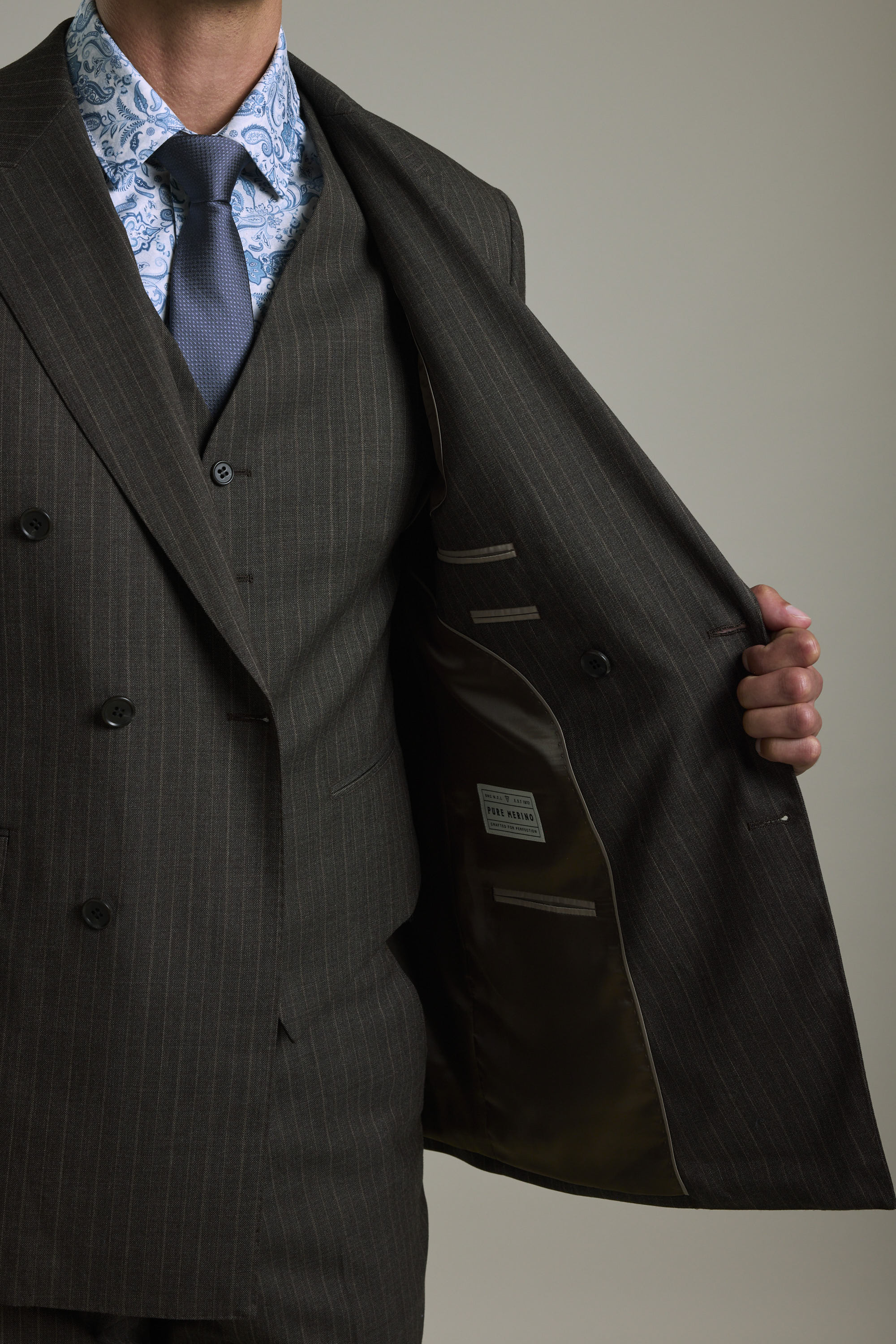 Man in a Barkers Radcliffe Stripe Double Breasted Suit Jacket shows the merino wool lining.