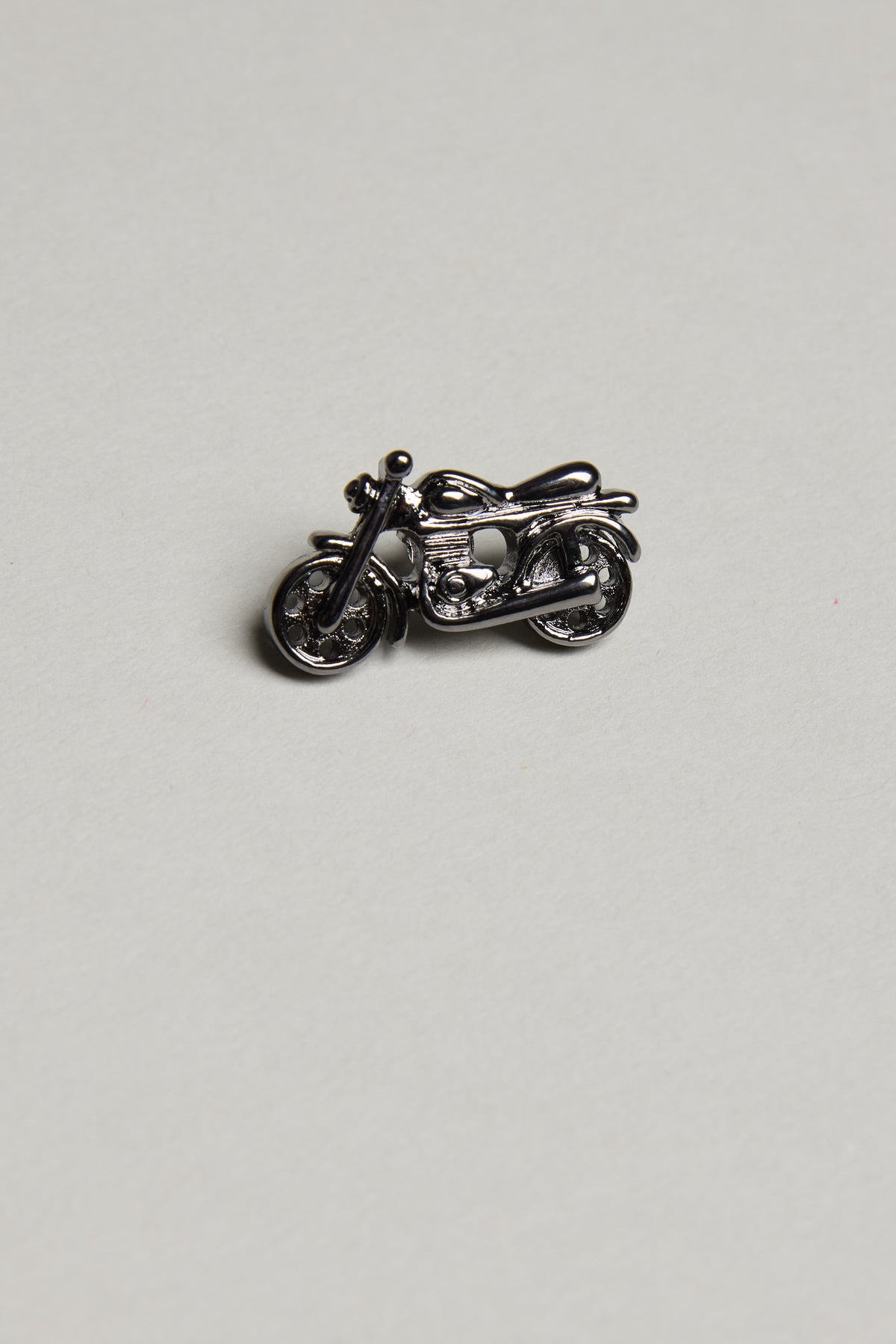 Barkers Motorbike Lapel Pin in gunmetal sits on a simple light gray background.