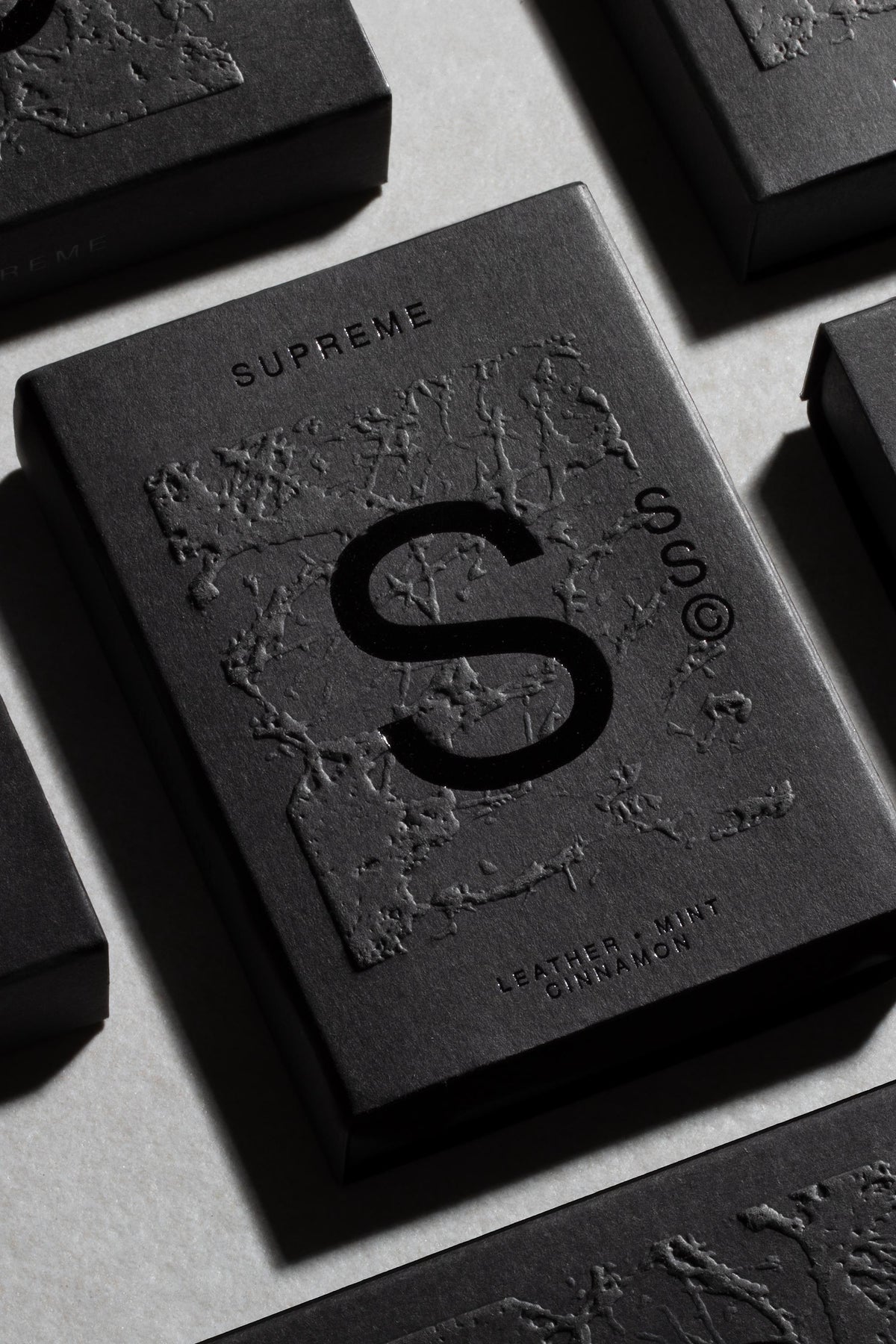 Solid State - Supreme: pocket cologne with textured black box, large S; Leather, Mint, Cinnamon.