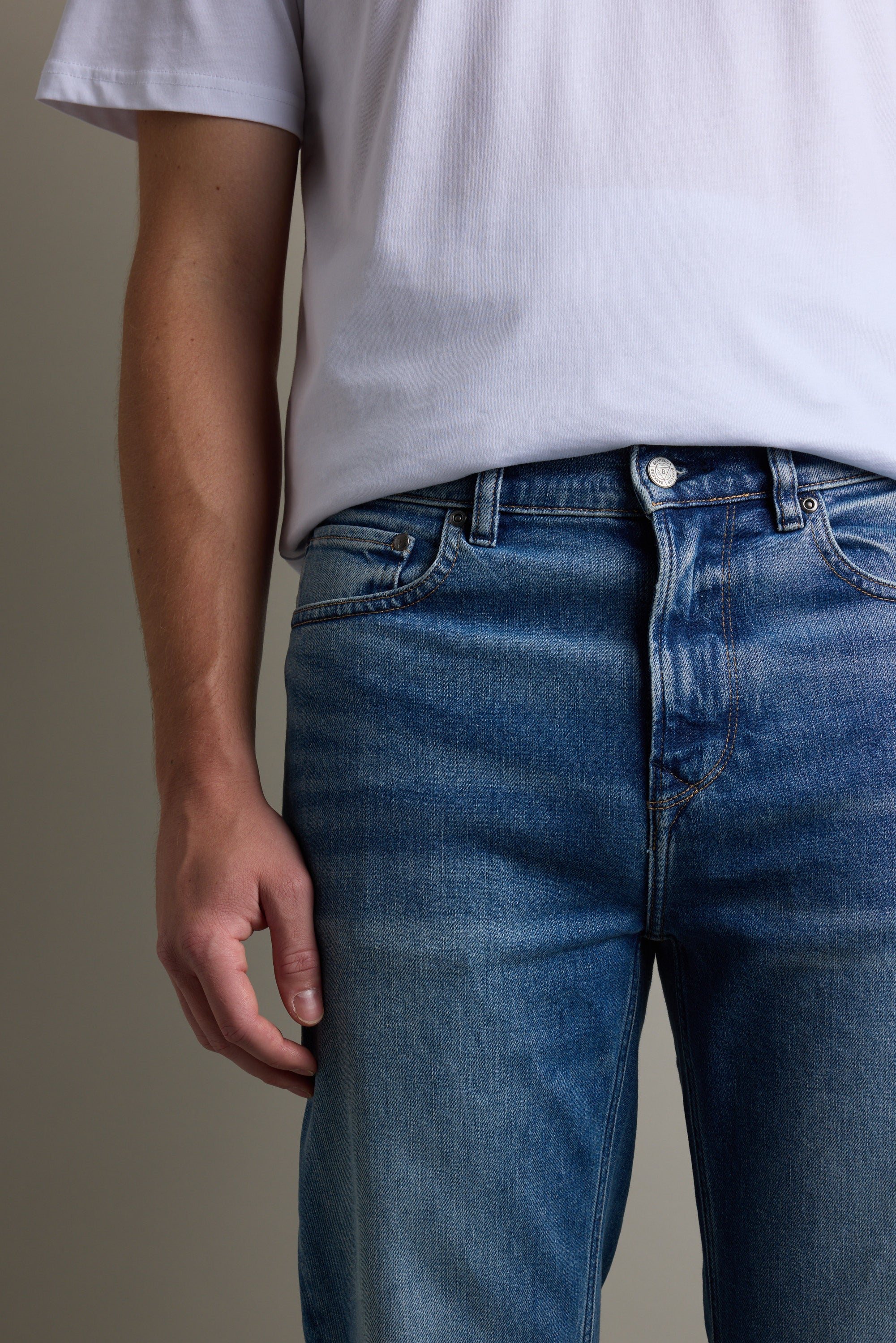 A person wears Barkers Drifter Denim Relax Jean and a white t-shirt, standing casually.