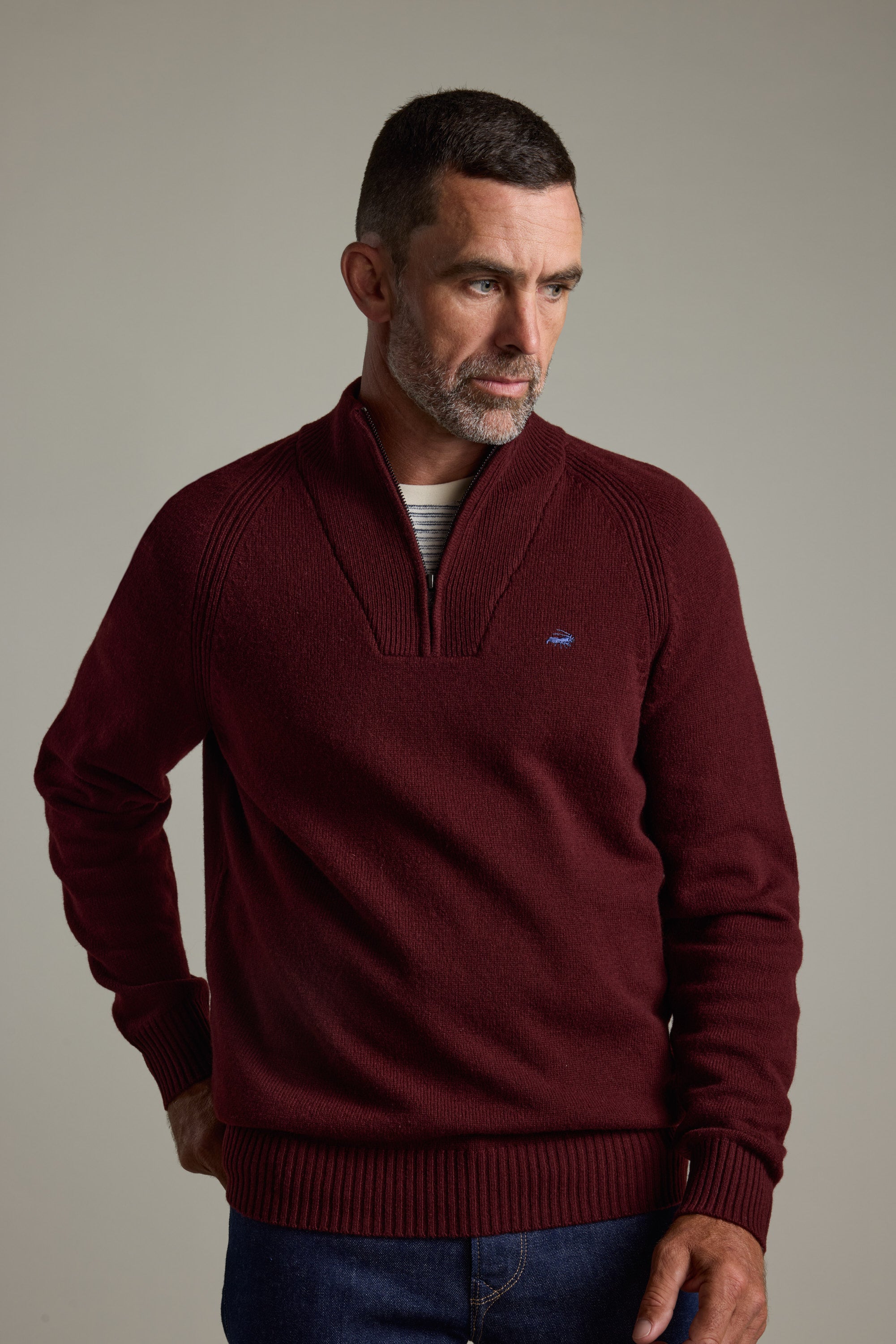 Man wearing Barkers Rowley Woollen 1/4 Zip, maroon, with a serious expression, plain background.