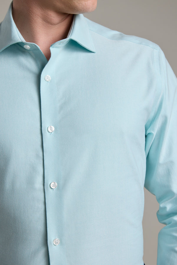 A man wears the Barkers Edgar Texture Business Shirt in light blue cotton with white buttons, shown from shoulders to waist and facing slightly to the side. His face is partially out of frame.