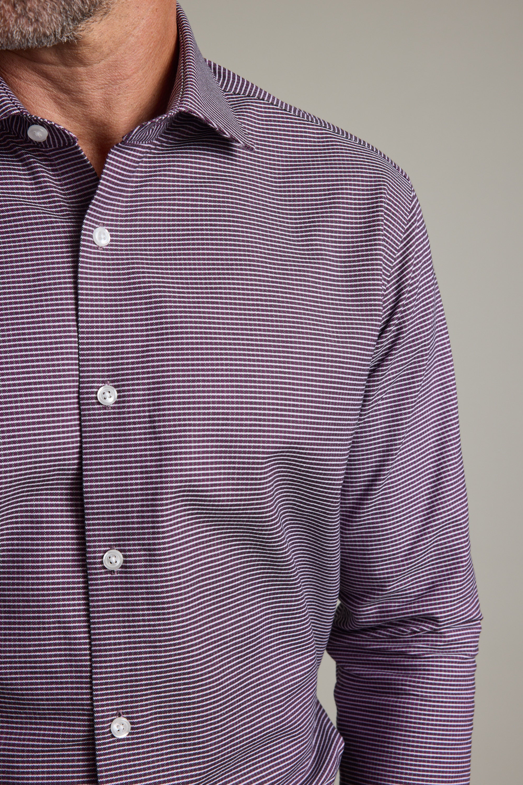A man wears the Barkers Waverly Check Business Shirt, featuring a purple and white checkered pattern and collar. The tailored fit offers style and comfort, visible in this close-up against a plain background.