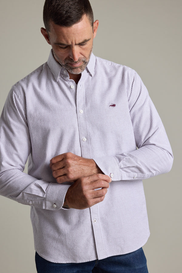 Man in a Barkers Maynard Oxford Stripe Shirt fastens his cuff while looking down.
