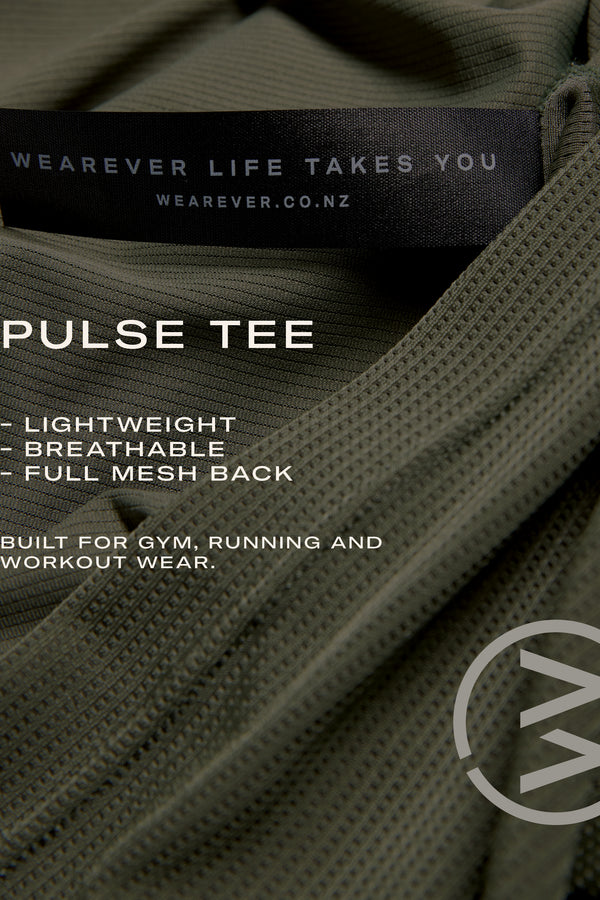Close-up of the olive green WearEver Pulse Tee, a lightweight, breathable performance shirt with a full mesh back and black WEARVER LIFE TAKES YOU label. Designed by WearEver for moisture-wicking comfort at the gym or running.