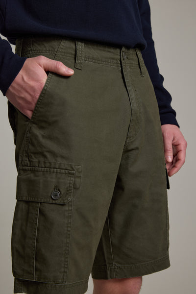A person wearing Barkers Astor Cargo Shorts with pockets and a dark long-sleeve shirt, standing with one hand in the pocket against a neutral background.