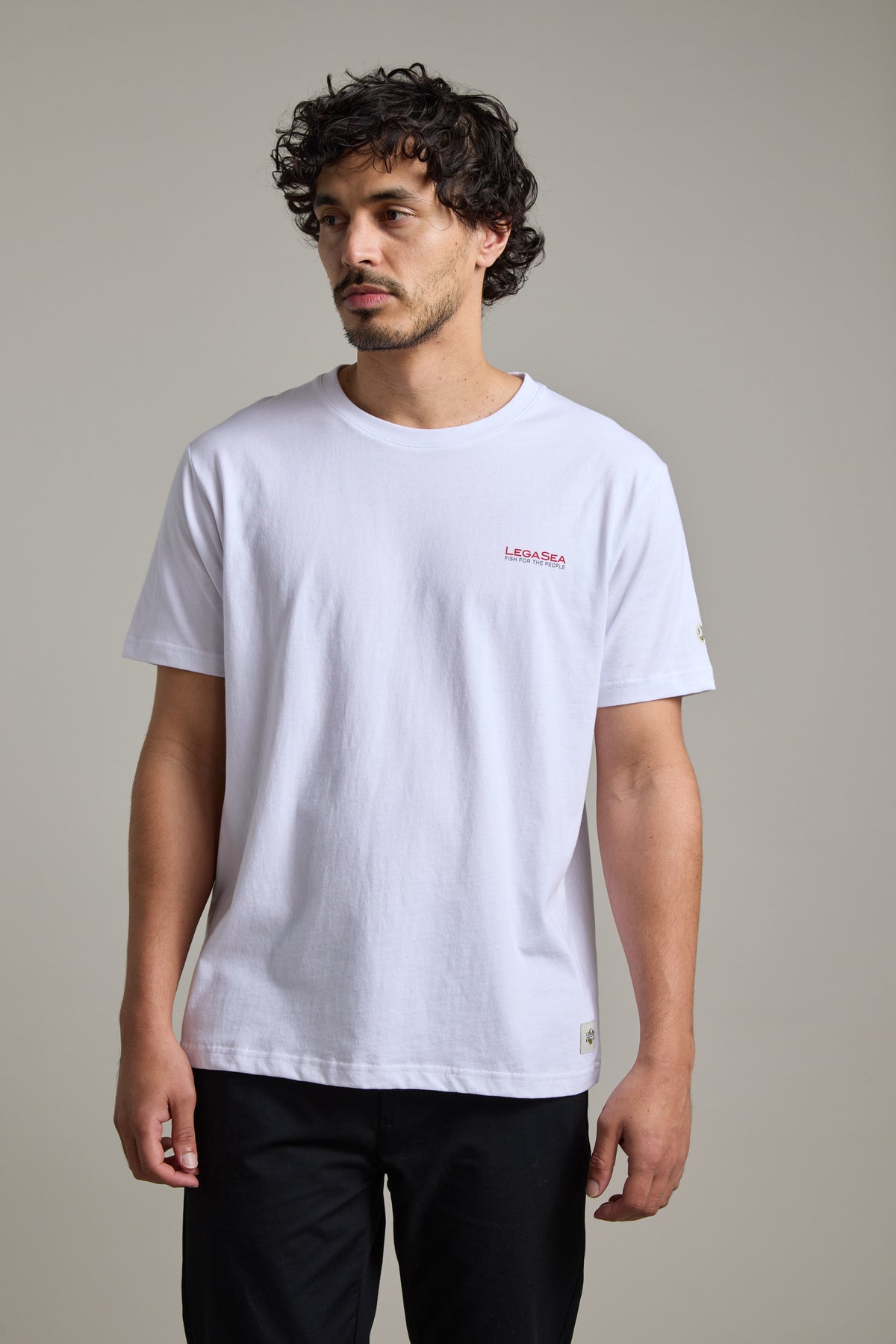 Man in a Legasea Brand Tee and black pants, inspired by New Zealand’s marine environment.