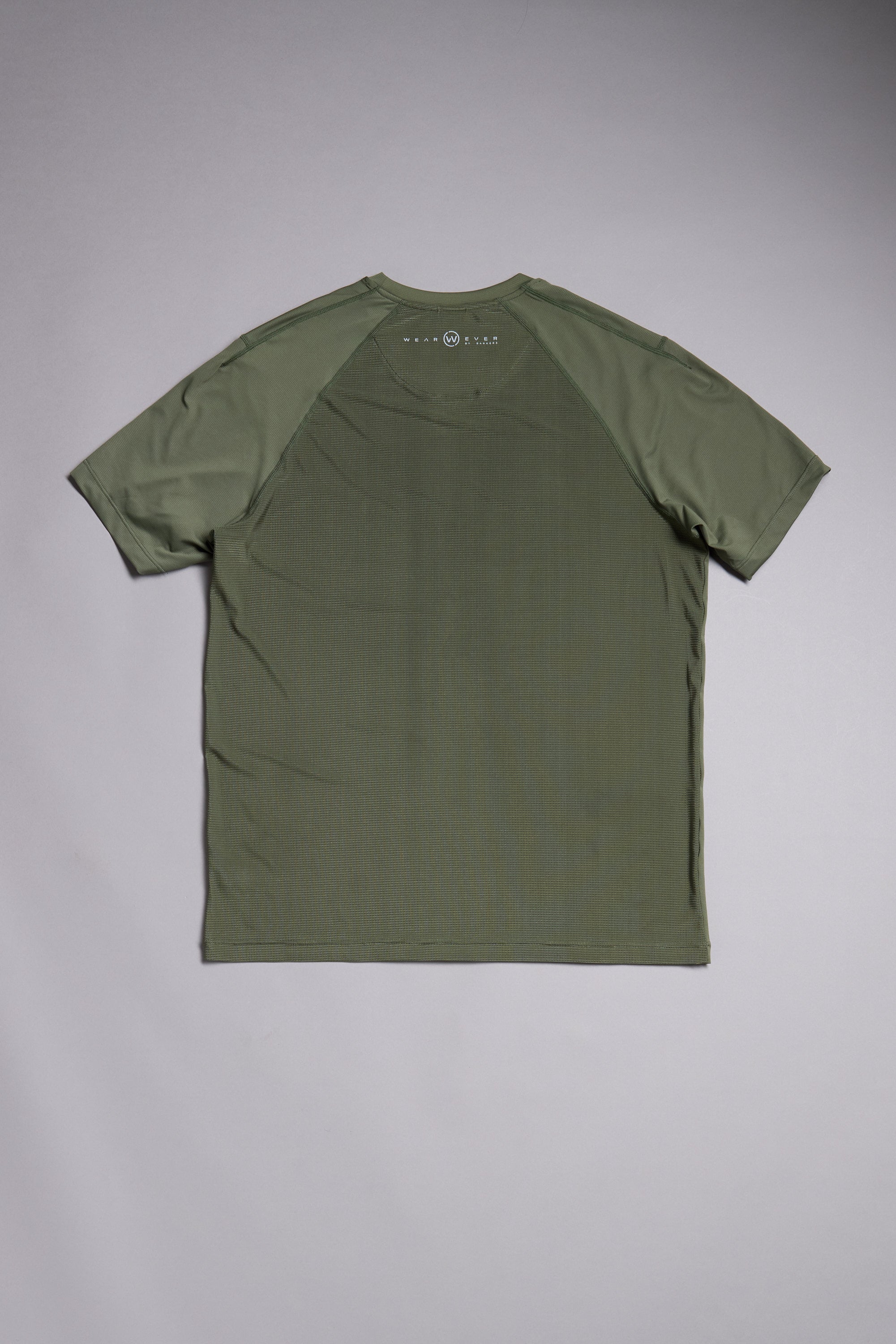 The WearEver Pulse Tee by WearEver is a plain olive green performance t-shirt, shown flat from the back, featuring raglan sleeves, moisture-wicking fabric, and a small circular logo near the neckline.