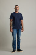 Man with short hair in a Barkers Good Earth Cotton Essential Tee poses confidently.