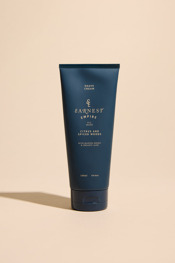 Other Earnest Empire Foaming Shave Cream tube for sensitive skin on a beige background.
