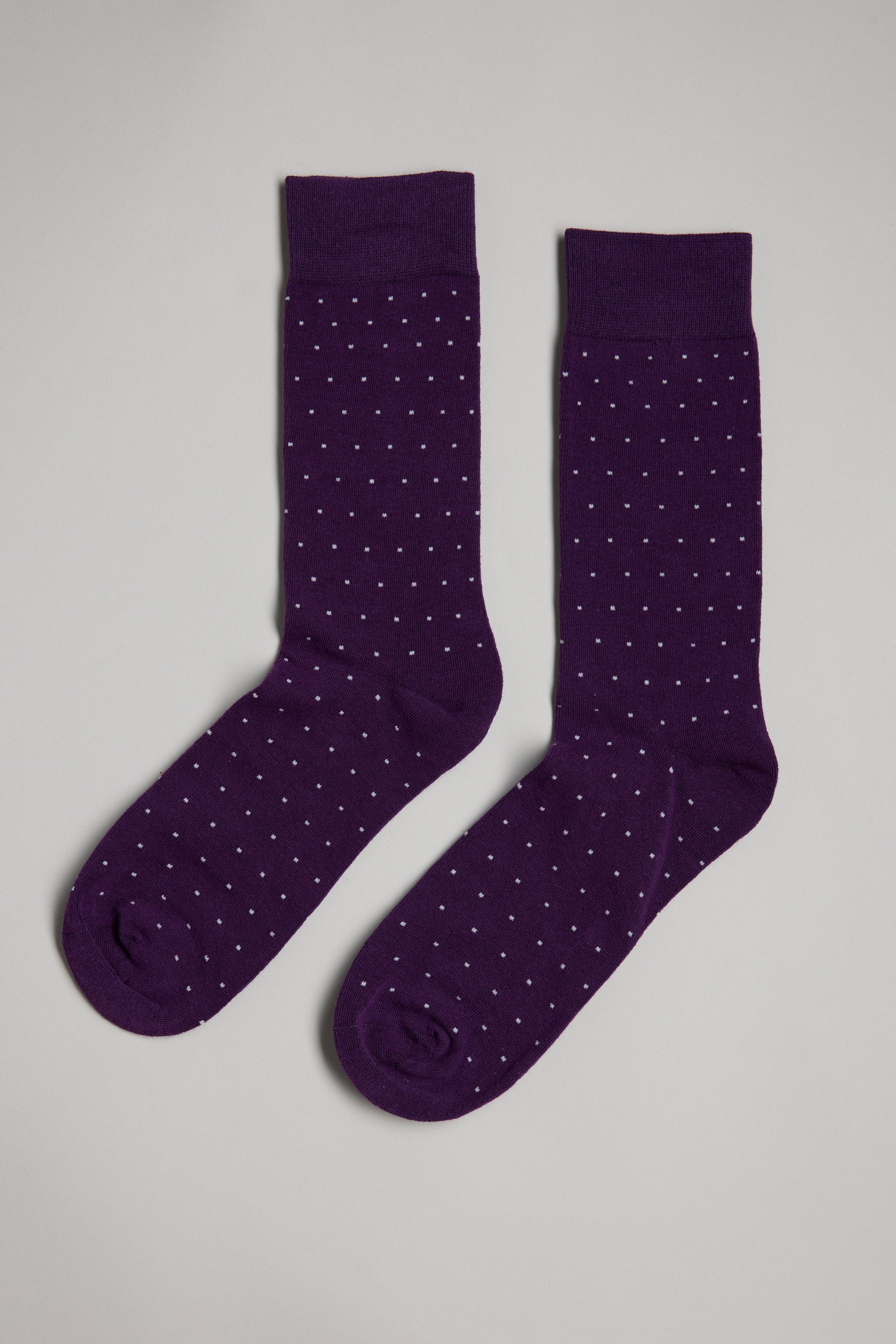 The Barkers Mercer Dot Sock in purple features a subtle pin-dot pattern and is designed for comfortable wear, shown laid side by side on a light gray background.