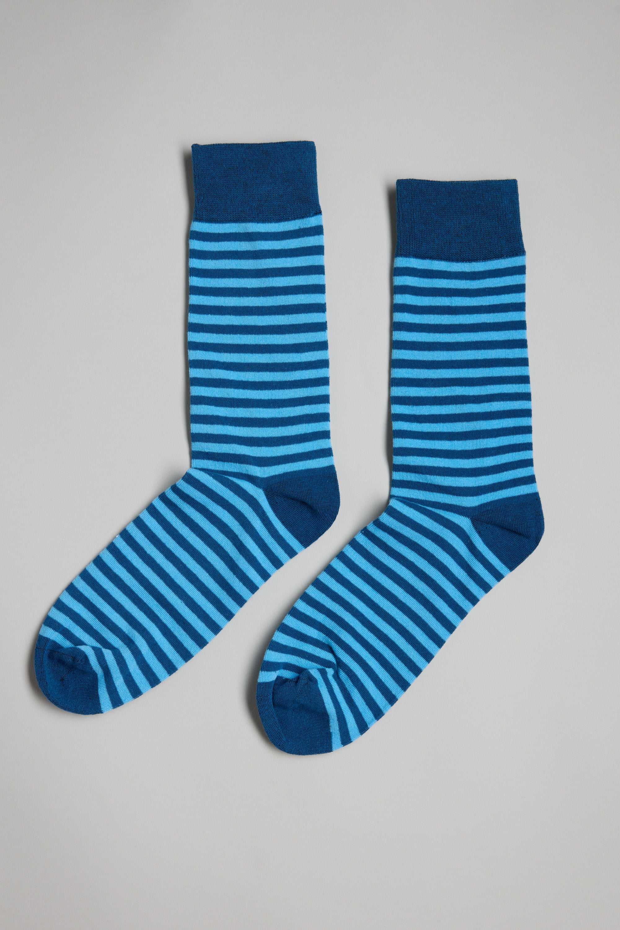 A pair of Barkers Evans Stripe cotton socks featuring horizontal light and dark blue stripes, laid flat on a light gray background—an ideal stylish gift for men.