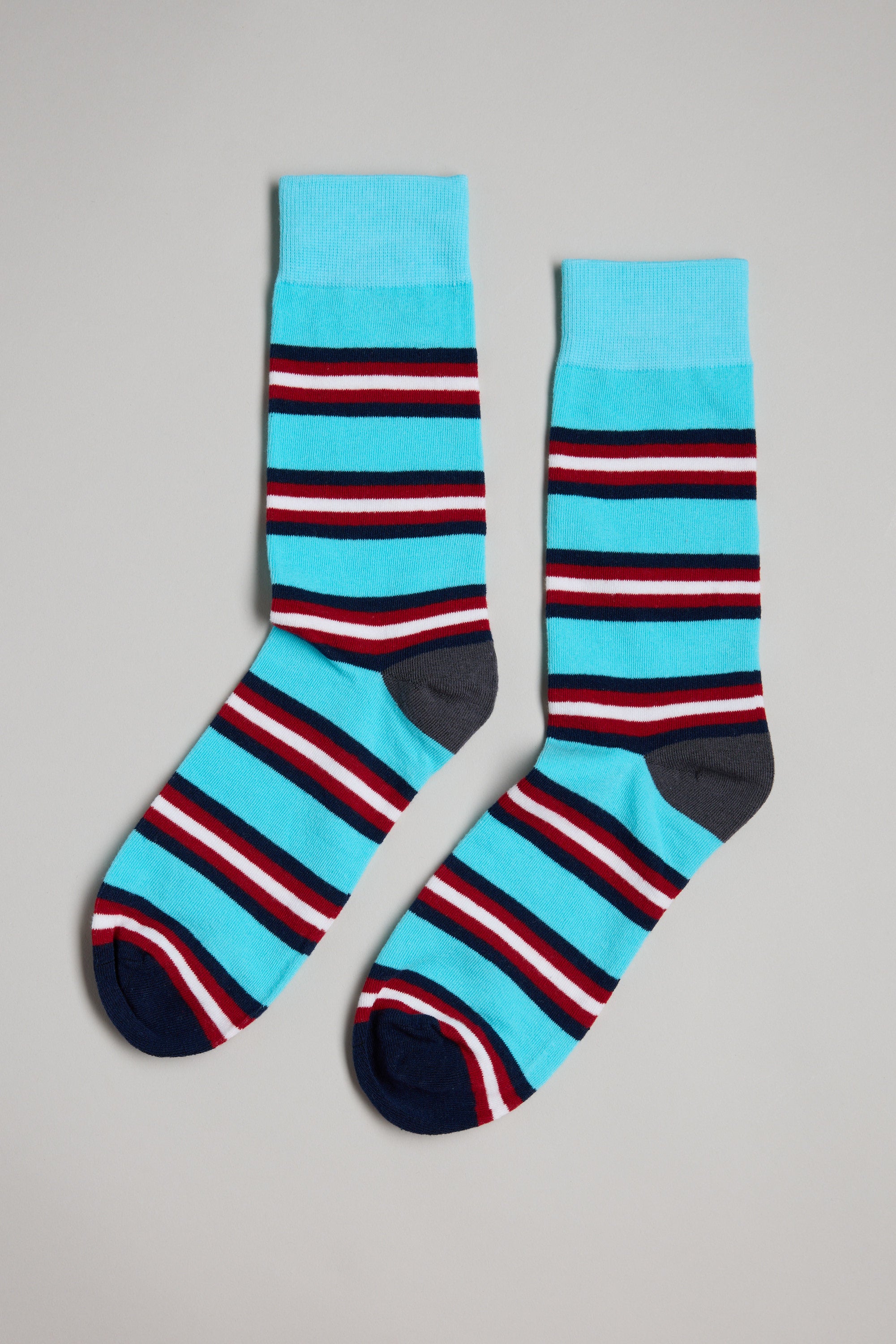 The Barkers Altona Stripe Sock features bright blue cotton with red, white, and black stripes, dark blue toes, and gray heels—perfect for anyone who appreciates stylish men's socks or a thoughtful gift for dad.