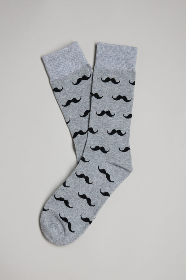 A pair of Barkers Moustache Socks in gray with light gray cuffs and a repeating black mustache pattern, laid out on a white surface—fun for Christmas gifting or as a quirky Secret Santa present.