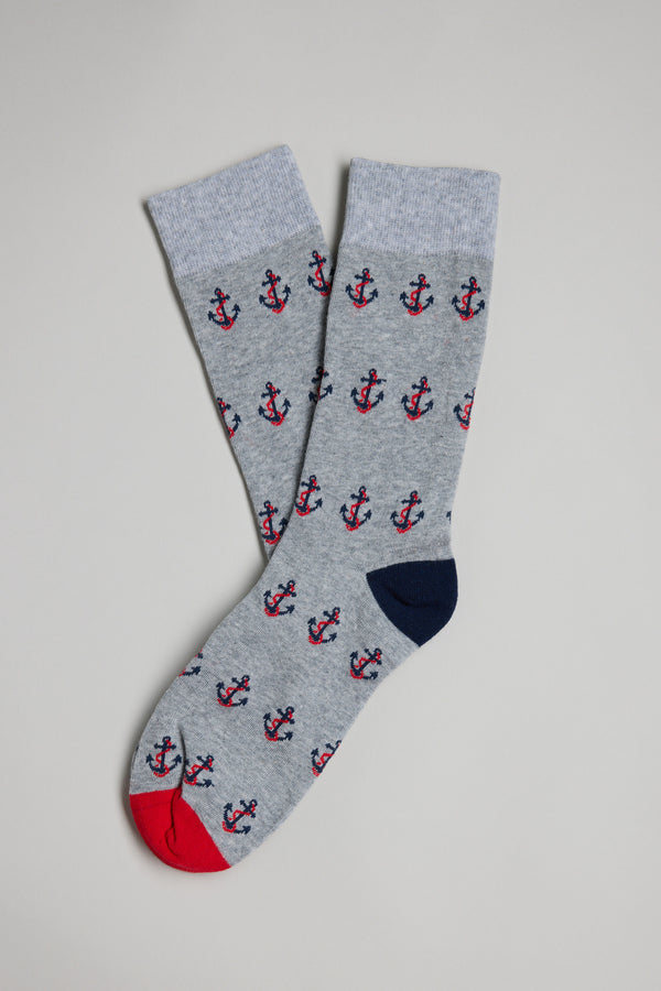 The Barkers Anchor Sock is a pair of men's grey cotton socks with red and navy anchor patterns, featuring a red toe on one sock and a navy toe on the other—making them the perfect gift.