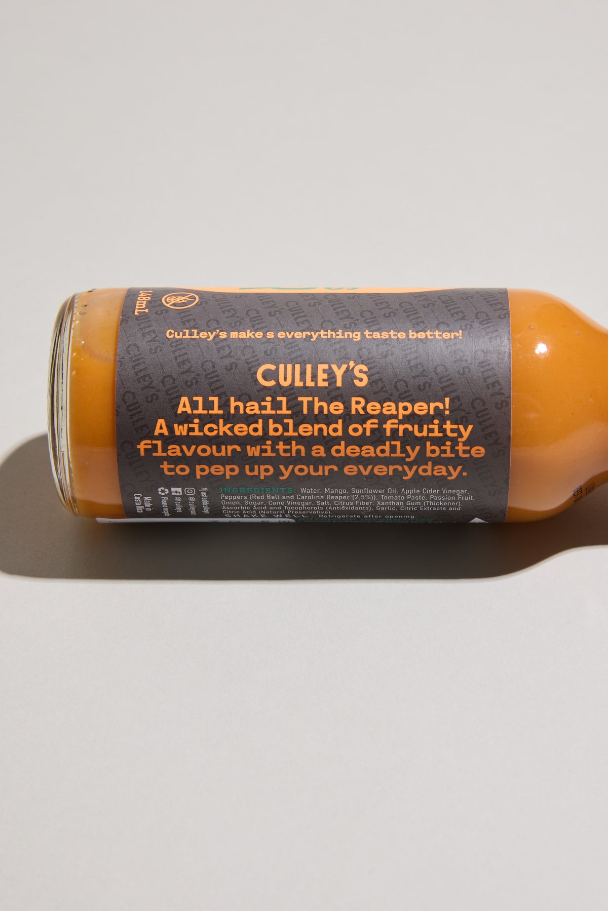 Culley’s Furious Reaper Hot Sauce bottle on its side, label says All hail The Reaper!.
