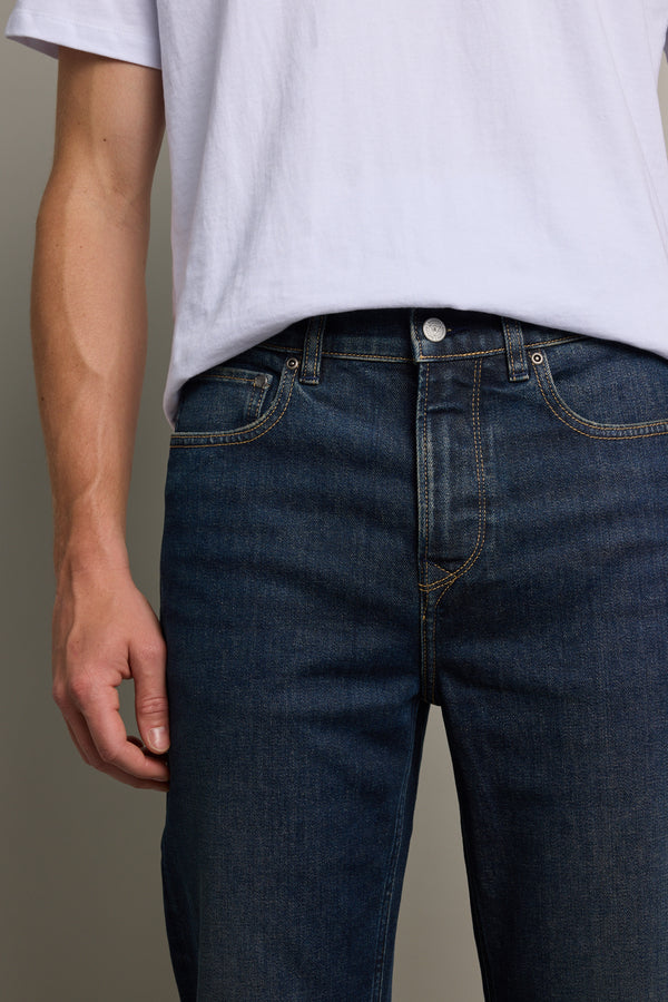 A person wearing a plain white T-shirt and Barkers Wanderer Denim Straight Jeans is shown from shoulders to thighs, with one arm relaxed by their side against a neutral background.